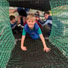 Children crawling through adventure nets at Out of Bounds