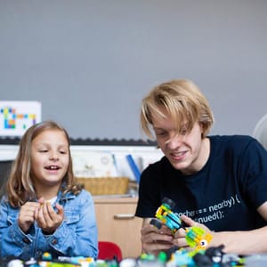 Coding teacher helping children at Blueshift Education