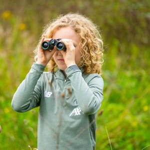Child using binoculars at Chester Zoo
