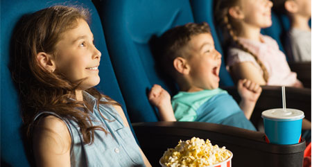 smiling children sitting in cinema