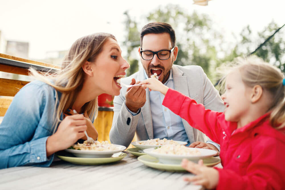 family eating outside at restaurant