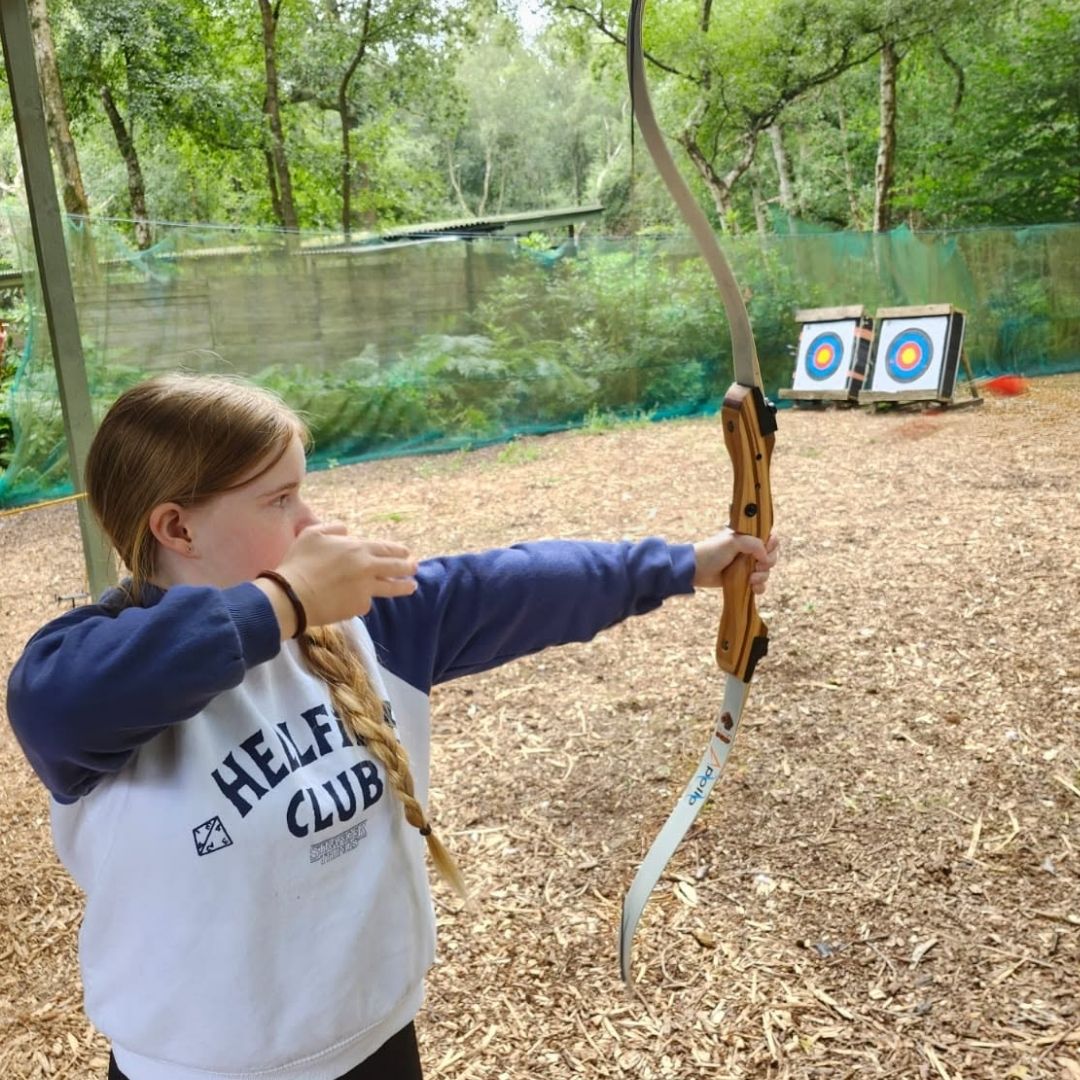 Child trying archery at Adventure Now Manchester