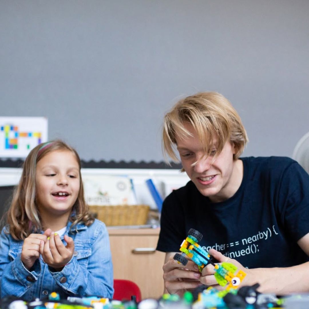 Coding teacher helping children at Blueshift Education
