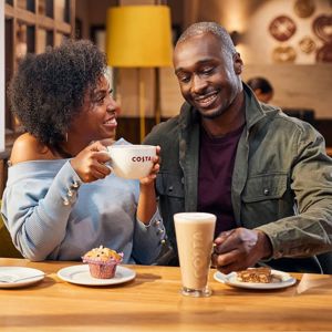Friends Enjoying Coffee and Cake at Costa Coffee