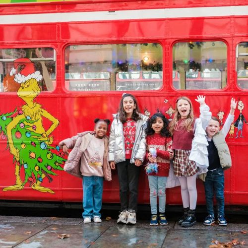 Family outside the Grinchmas Afternoon Tea Bus