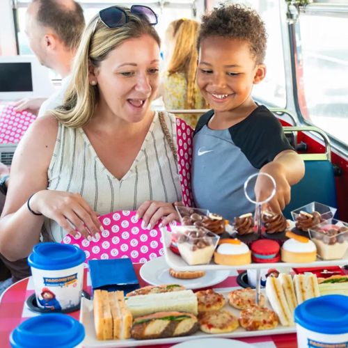 Family enjoying Paddington afternoon tea on the bus