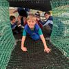 Children crawling through adventure nets at Out of Bounds