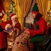 Santa and elf preparing Christmas gifts