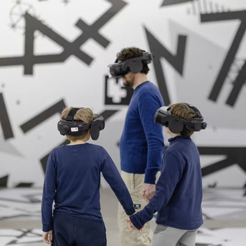 Family exploring Space Explorers VR experience