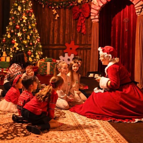 Children enjoying Christmas storytelling with Santa